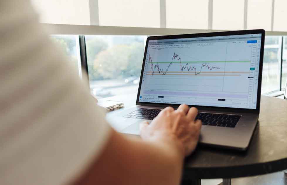 a man checking the type of stock orders on his laptop